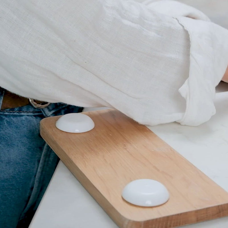 White protectors used as feet under a cutting board